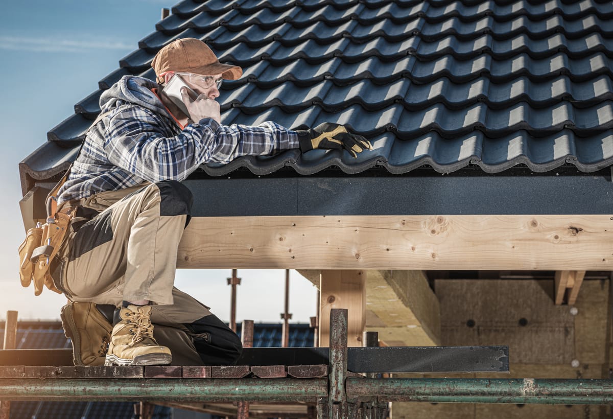 Roofing contractor inspecting a roof