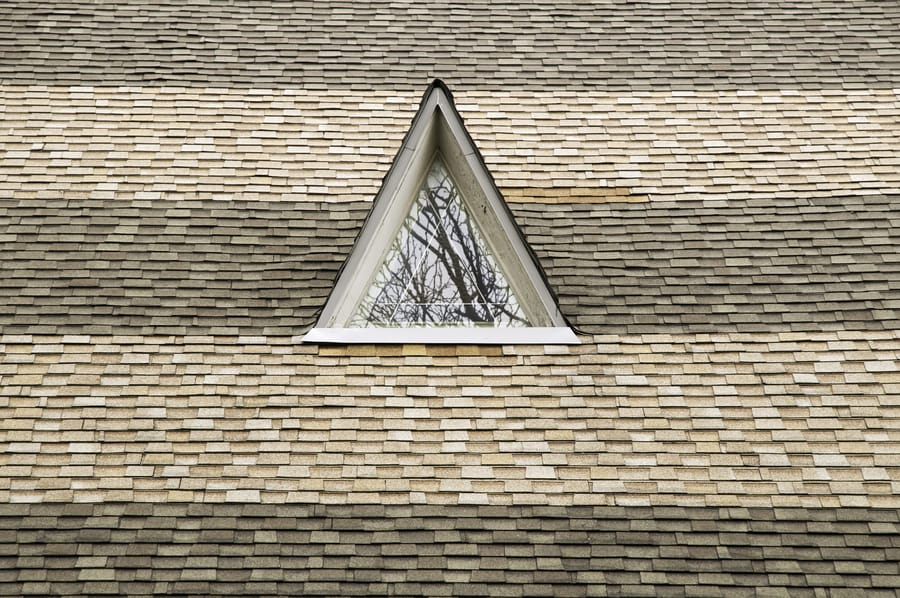 Roofing contractor measuring a roof square